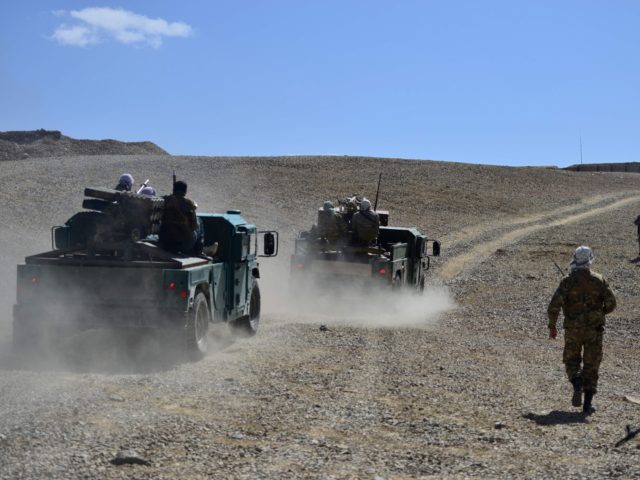 Afghan resistance movement and anti-Taliban uprising forces personnel patrol at an outpost
