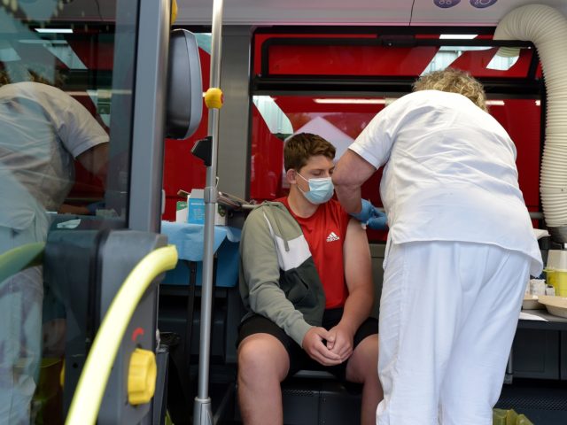 BOLZANO, ITALY - JULY 14: People receive their Covid-19 vaccine in one of two SASA buses e