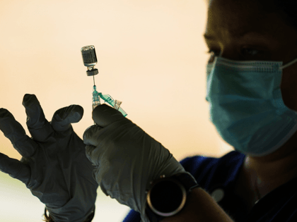 In this Sept. 14, 2021 file photo, a syringe is prepared with the Pfizer COVID-19 vaccine at a clinic at the Reading Area Community College in Reading, Pa. Businesses that have announced vaccine mandates say some workers who had been on the fence have since gotten inoculated against COVID-19. But …
