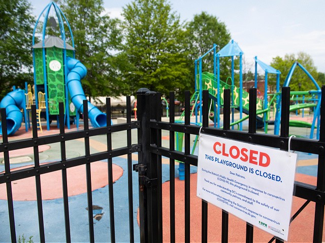 A signs hangs outside a closed playground in Washington, DC, April 29, 2020. - Washington will uphold coronavirus restrictions through May 15, 2020. (Photo by SAUL LOEB / AFP) (Photo by SAUL LOEB/AFP via Getty Images)