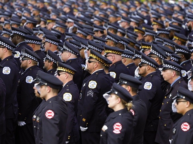 Chicago police and firefighters salute as the body of slain Chicago police officer Ella French is carried into the St. Rita of Cascia Shrine Chapel for a funeral service Thursday, Aug. 19, 2021, in Chicago. French was killed and her partner was seriously wounded during an Aug. 7 traffic stop on the city's South Side. (AP Photo/Charles Rex Arbogast)