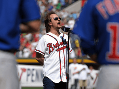 In this April 5, 2010, file photo, county music singer Travis Tritt sings the national anthem before a baseball game between the Atlanta Braves and the Chicago Cubs in Atlanta. Tritt will perform the national anthem prior to the NCAA Final Four college basketball championship game between Michigan and Louisville …