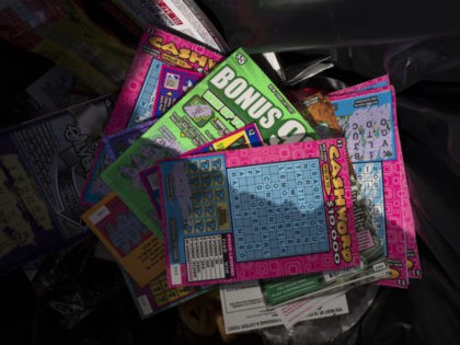 Used scratch off games from the New York Lottery are discarded in a trash can, Tuesday, Ma