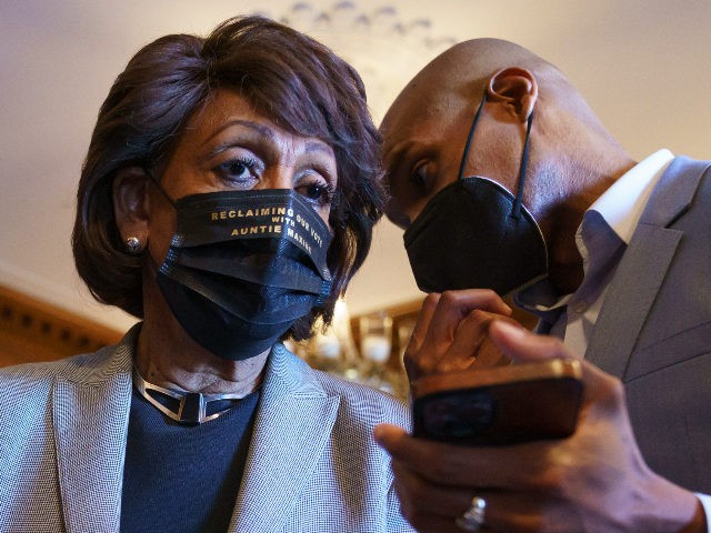 Rep. Maxine Waters, D-Calif., listens to an aide as she joins members of the Congressional