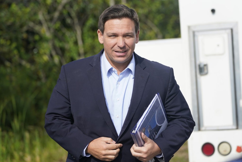 Florida Gov. Ron DeSantis arrives at a news conference, Tuesday, Aug. 3, 2021, near the Shark Valley Visitor Center in Miami. DeSantis is doubling down as the state again broke its record for COVID-19 hospitalizations. The Republican governor insisted Tuesday that the spike will be short-lived. (AP Photo/Wilfredo Lee)
