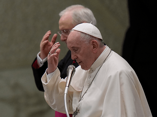 Pope Francis, flanked by Father Leonardo Sapienza, left, begins the weekly general audienc
