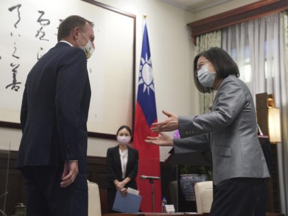 Taiwanese President Tsai Ing-wen, right, reacts to former Australian Prime Minister Tony Abbott during a meeting at the Presidential Office in Taipei, Taiwan, Thursday, Oct. 7, 2021. Abbott met Tsai during a trip that comes in a particularly tense moment between Taiwan and China. (Pool Photo via AP Photo)