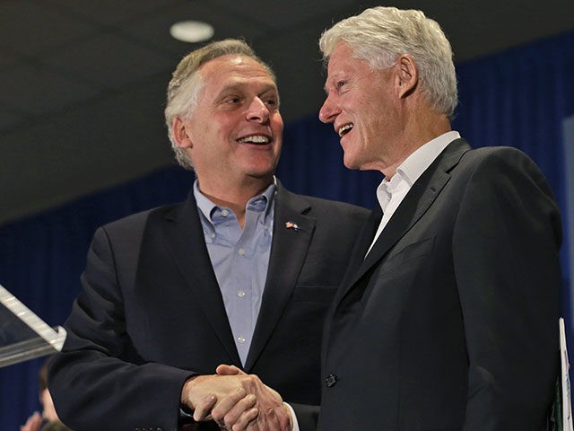 Former President Bill Clinton, right, greets Virginia Democratic gubernatorial candidate Terry McAuliffe during a rally at James Madison University in Harrisonburg, Va., Tuesday, Oct. 29, 2013. Clinton has attended rallies around the state to give his support to McAuliffe. (AP Photo/Steve Helber)