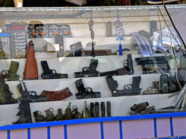 Pistols, hand grenades, and ammunition are seen kept on display for sale at a shop in Panjwai district of Kandahar province on September 4, 2021. (Javed Tanveer/AFP via Getty Images)