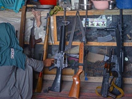 An Afghan vendor displays guns for sale as he waits for customers in his shop at a market in Panjwai district of Kandahar province on September 4, 2021. (Javed Tanveer/AFP via Getty Images)