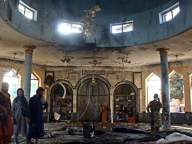 Taliban fighters investigate inside a Shiite mosque after a suicide bomb attack in Kunduz on October 8, 2021. (AFP via Getty Images)