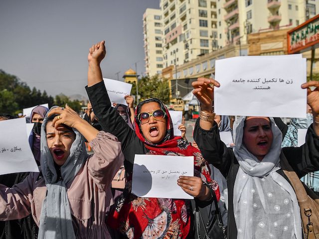 Afghan women chant slogans and hold placard during a women's rights protest in Kabul on October 21, 2021. (Bulent Kilic/AFP via Getty Images)