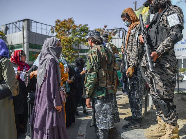 Taliban members stop women protesting for women's rights in Kabul on October 21, 2021. (Bulent Kilic/AFP via Getty Images)
