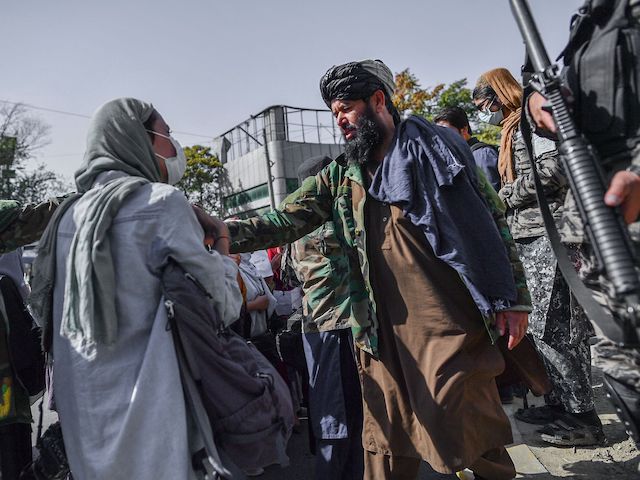 Taliban members stop women protesting for women's rights in Kabul on October 21, 2021. (Bulent Kilic/AFP via Getty Images)
