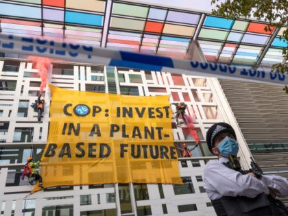 LONDON, ENGLAND - OCTOBER 26: Environmental activists scale the Home Office on October 26, 2021 in London, England. Protesters dropped a banner from the building reading "COP: Invest In A Plant-Based Future," referring to the upcoming United Nations Conference On Climate Change (COP26) in Glasgow that starts this weekend. (Photo …