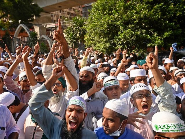Activists of Islami Andolan Bangladesh, an Islamist political party take part in a protest outside the National Mosque in Dhaka on October 16, 2021, as protests began on October 13 after footage emerged of a Koran being placed on the knee of a figure of a Hindu god during celebrations …
