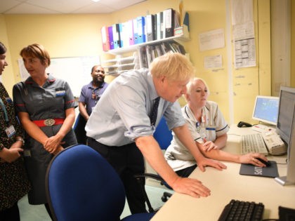HARLOW, ENGLAND - SEPTEMBER 27: Prime Minister Boris Johnson speaks with staff during a visit to the Princess Alexandra hospital for an announcement on new patient scanning equipment on September 27, 2019 in Harlow, United Kingdom. The Prime Minister is pledging an overhaul to cancer screening, with the funding providing …