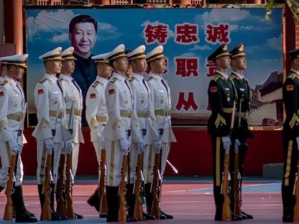 Military personnel stand in formation next to a portrait of China's President Xi Jinping (back) outside the Forbidden City in Beijing on October 22, 2020, on the eve of the 70th anniversary of Chinas entry into the 1950-53 Korean War. (Photo by NICOLAS ASFOURI / AFP) (Photo by NICOLAS ASFOURI/AFP …