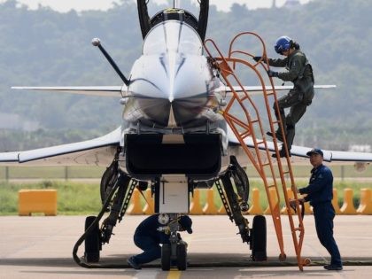 A female pilot exits the cockpit of a Chengdu Aircraft Corporation's J-10 for the People's Liberation Army Air Force (PLAAF) after a flight demonstration programme at the 13th China International Aviation and Aerospace Exhibition in Zhuhai, in southern China's Guangdong province on September 28, 2021. (Noel Celis/AFP via Getty Images)