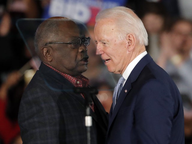 Then Democrat presidential candidate Joe Biden talks to Rep. James Clyburn (D-SC) at a primary night election rally in Columbia, SC, February 29, 2020, after winning the South Carolina primary. (AP Photo/Gerald Herbert)