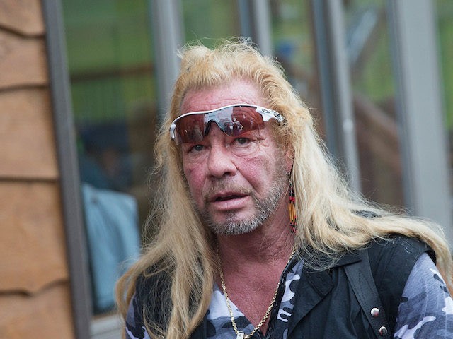 Dog the Bounty Hunter, Duane Chapman, films a segment of his television show outside of a news conference where then-Gov. Andrew Cuomo (D-NY) spoke to the media about the capture of convicted murderer David Sweat on June 28, 2015 in Malone, New York. (Scott Olson/Getty Images)