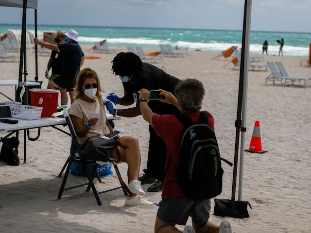 A woman gets a Johnson & Johnson coronavirus vaccine at a pop-up vaccination center at the beach, in South Beach, Florida, on May 9, 2021. (Eva Marie Uzcategui/AFP via Getty Images)