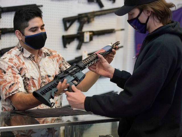 A customer looks at a custom made AR-15 style rifle at Davidson Defense in Orem, Utah on February 4, 2021. (George Frey/AFP via Getty Images)