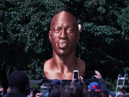 People take photos of the George Floyd statue as the Immersive art organization, Confront Art, in collaboration with the NYC Parks, unveils the SEENINJUSTICE exhibit, featuring three sculptures by Chris Carnabucci: George Floyd, Breonna Taylor and John Lewis, at Union Square Park in New York, on September 30, 2021. MANDATORY …