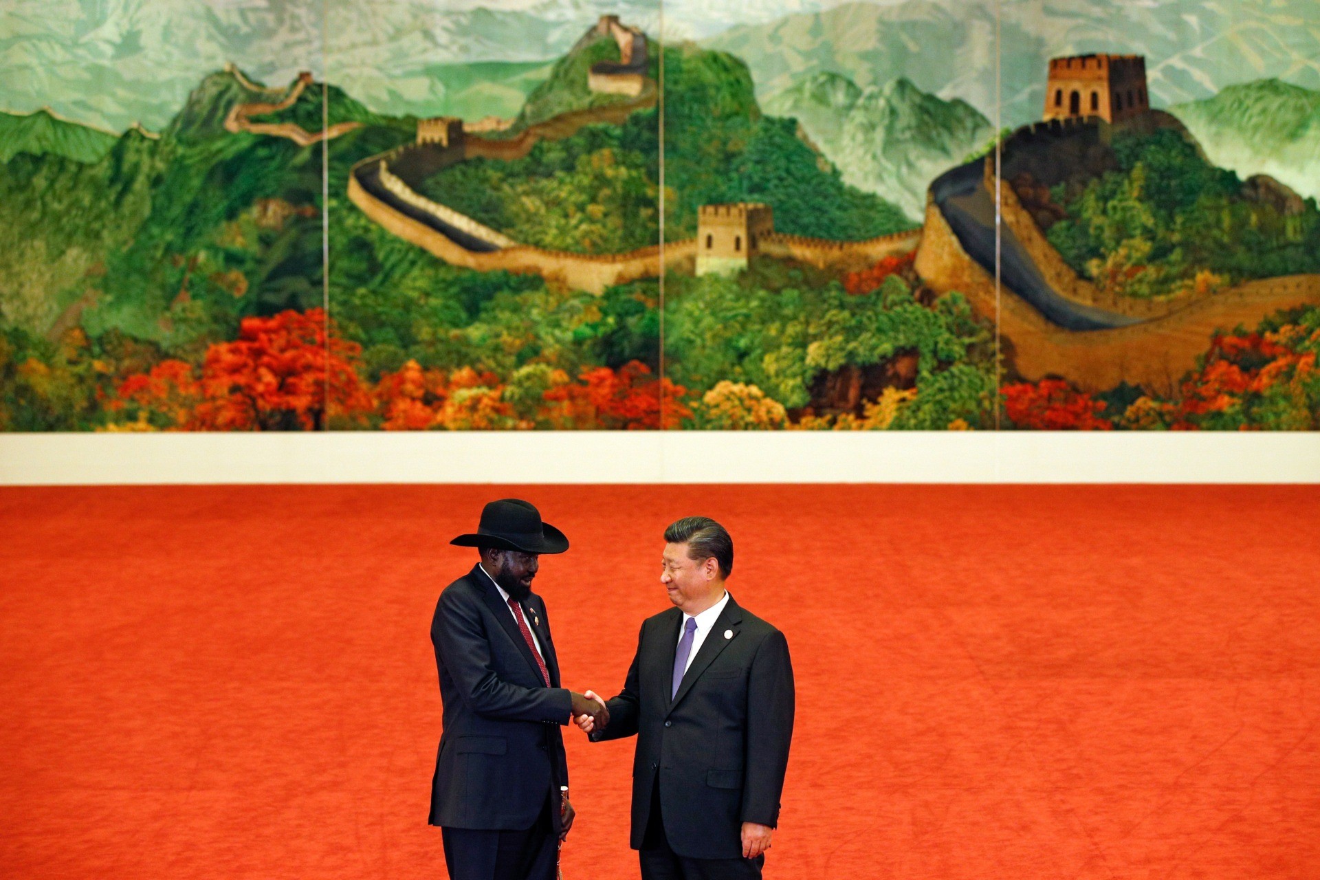 South Sudan's President Salva Kiir (L) shakes hands with China's President Xi Jinping during the Forum on China-Africa Cooperation at the Great Hall of the People in Beijing on September 3, 2018. - President Xi Jinping told African leaders on September 3 that China's investments on the continent have "no political strings attached", pledging $60 billion in new development financing, even as Beijing is increasingly criticised over its debt-heavy projects abroad. (Photo by Andy Wong / POOL / AFP) (Photo credit should read ANDY WONG/AFP via Getty Images)