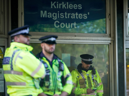 HUDDERSFIELD, ENGLAND - SEPTEMBER 05: A heavy police presence guards Kirklees Magistrates Court as 31 people appear charged as part of the Huddersfield sex abuse investigation on August 16, 2018 in Huddersfield, England. Thirty men and one woman are appearing at Kirlklees Magistrates Court facing charges in the wake of …