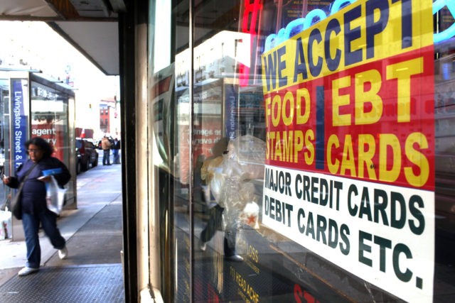 NEW YORK - OCTOBER 07: A sign in a market window advertises the acceptance of food stamps on October 7, 2010 in New York City. New York Mayor Michael Bloomberg is proposing an initiative that would prohibit New York City's 1.7 million food stamp recipients from using the stamps, a …