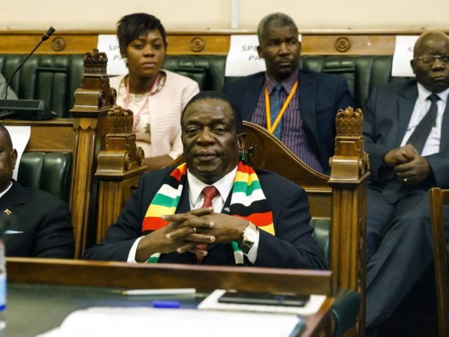 Zimbabwe President Emmerson Mnangagwa (C) looks on as members of the Zimbabwe Republic Police (ZRP) enter to eject opposition party Members of Parliament who refused to be upstanding when he entered the chambers for Minister of Finance's presentation of his budget statement in the Parliament of Zimbabwe November 22, 2018 …