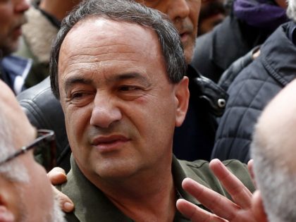 Domenico Lucano (C), the former mayor of Riace and accused of setting up fake marriages to help foreign women stay in the country after their asylum applications were rejected, arrives at Rome's Sapienza University on May 13, 2019 in Rome, to deliver a speech to the students of the University. …