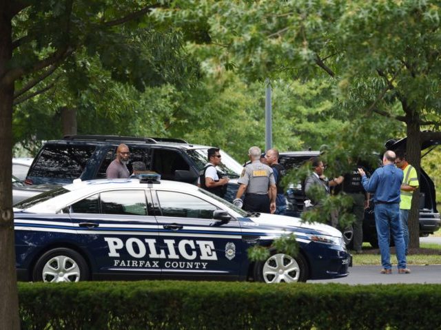 Police and first responders gather at the Gannett headquarters, home of USA Today, in McLean, Virginia, on August 7, 2019. - The newspaper USA Today evacuated its headquarters in northern Virginia on Wednesday following an alleged sighting of an armed man at the building, but later said the report was …