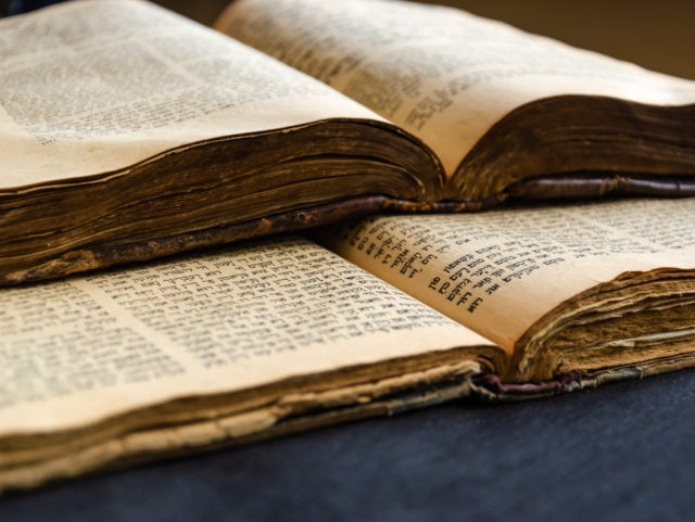 Jewish Bible. An open old Jewish books. Opened scripture pages. Selective focus. Close-up