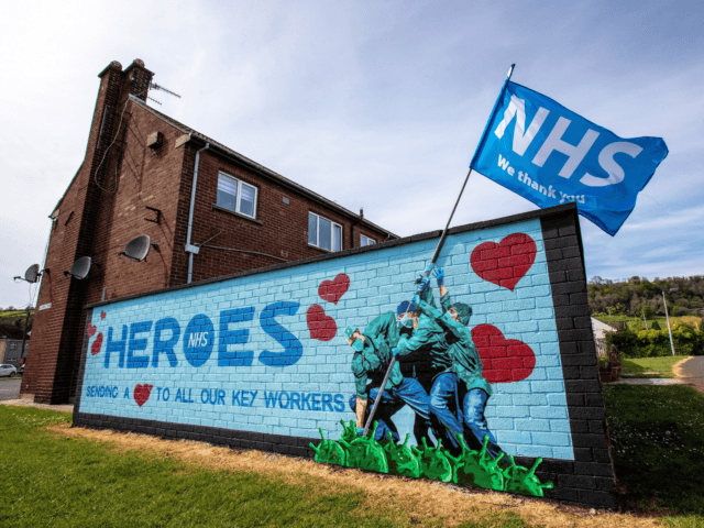 Street art graffiti paying tribute to the NHS, (National Health Service), is pictured on a wall in Glynn, north of Belfast on May 5, 2020. - The number of people killed by the coronavirus in the UK stands at 32,313, according to official figures on May 5 2020, the second …