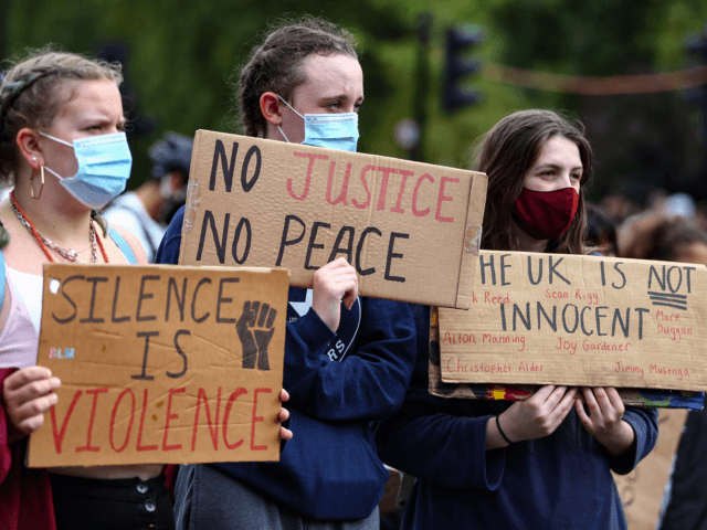 LONDON, ENGLAND - JUNE 28: Demonstrators hold placards during a Black Lives Matter march on June 28, 2020 in London, England. The protest movement, which began in solidarity with American demonstrations about the killing of George Floyd, has waned in intensity in here but continues to draw substantial crowds at …