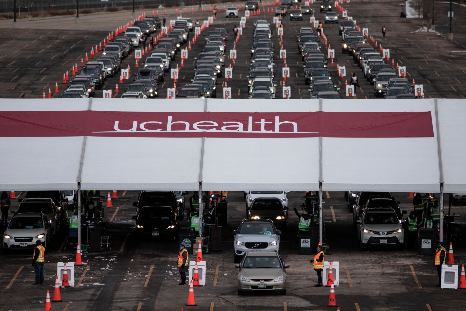 People arrive for Covid-19 vaccination at a drive through setup at Coors Field baseball stadium on January 30, 2021, in Denver, Colorado. - UCHealth, the organizer and Colorado's largest healthcare provider, has set the goal of vaccinating 10,000 people over the weekend. (Photo by Chet Strange / AFP) (Photo by CHET STRANGE/AFP via Getty Images)