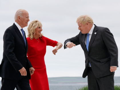 US President Joe Biden (L) watches as US First Lady Jill Biden (C) elbow bumps with Britain's Prime Minister Boris Johnson during the G7 summit in Carbis Bay, Cornwall, south-west England on June 11, 2021. (Photo by Patrick Semansky / POOL / AFP) (Photo by PATRICK SEMANSKY/POOL/AFP via Getty Images)