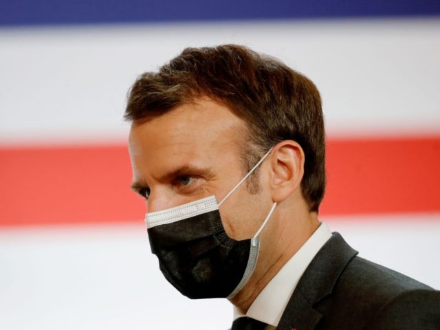 French President Emmanuel Macron wears a face mask during the launching of the French Stra