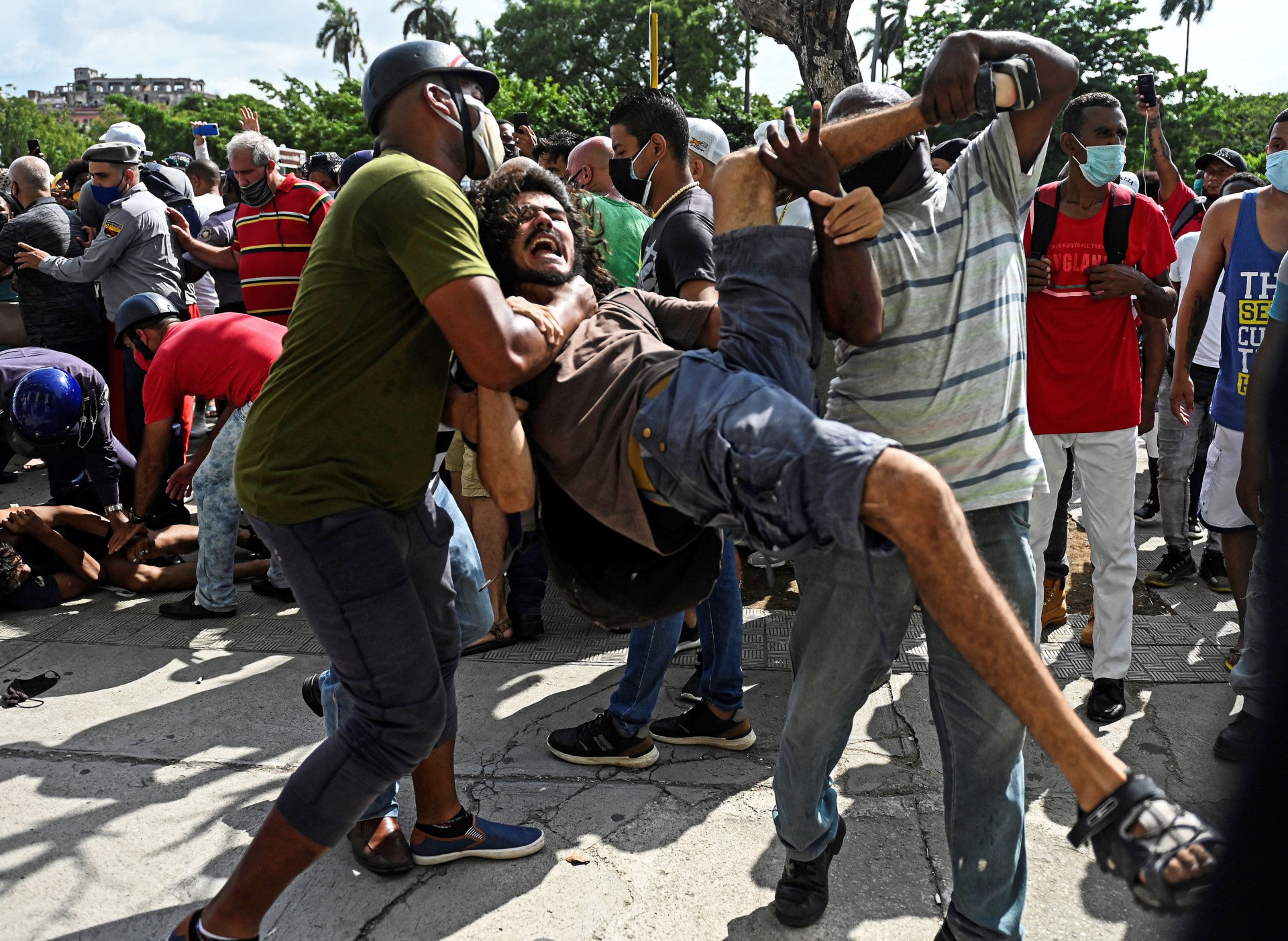 A man is arrested during a demonstration against the government of Cuban President Miguel Diaz-Canel in Havana, on July 11, 2021. - Thousands of Cubans took part in rare protests Sunday against the communist government, marching through a town chanting "Down with the dictatorship" and "We want liberty." (Photo by YAMIL LAGE / AFP) (Photo by YAMIL LAGE/AFP via Getty Images)