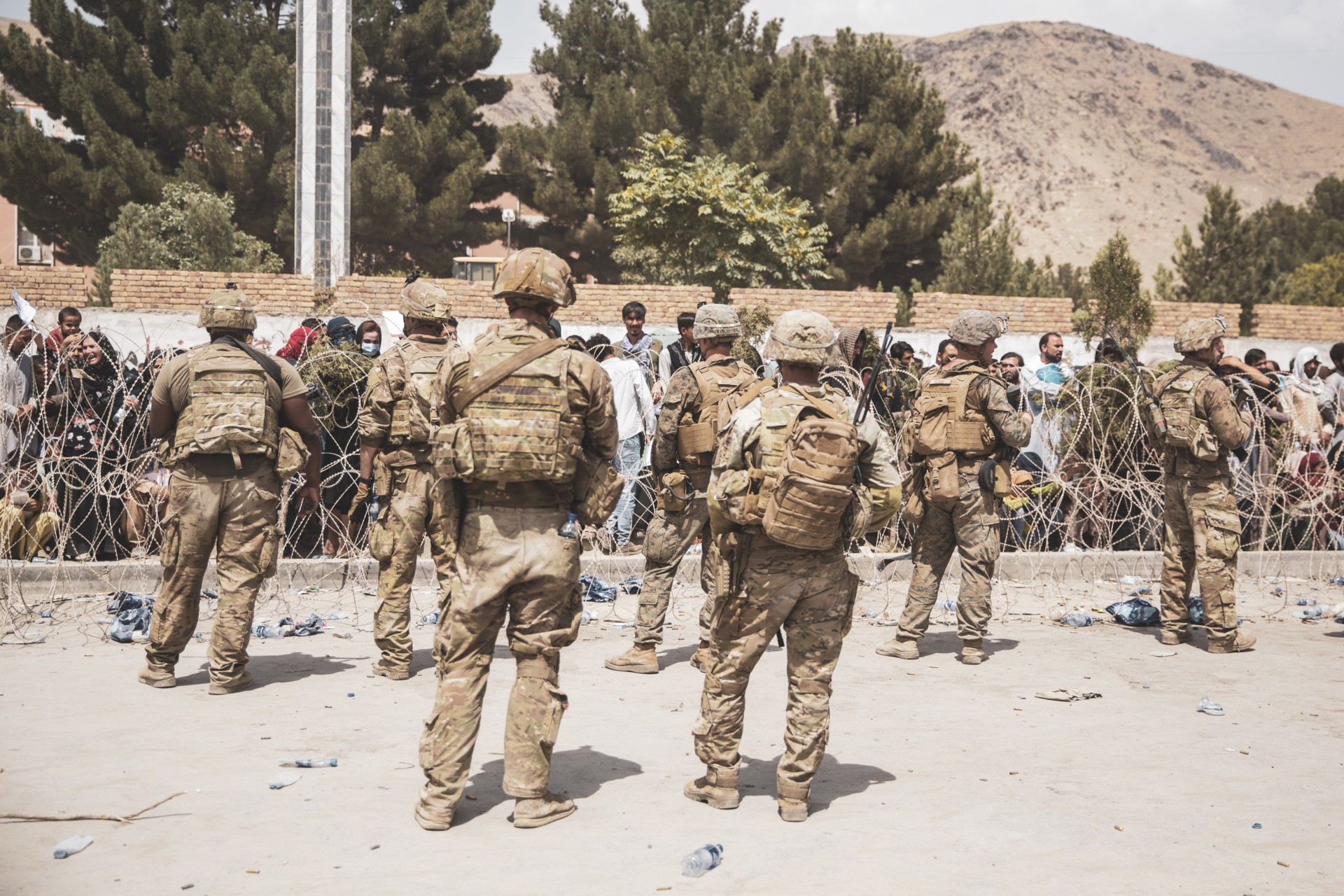 HAMID KARZAI INTERNATIONAL AIRPORT, AFGHANISTAN - AUGUST 19: This handout image shows U.S. Soldiers and Marines assist with security at an Evacuation Control Checkpoint during an evacuation at Hamid Karzai International Airport, August 19, 2021 in Kabul, Afghanistan. U.S. service members are assisting the Department of State with a non-combatant evacuation operation (NEO) in Afghanistan. (Photo by Staff Sgt. Victor Mancilla / U.S. Marine Corps via Getty Images)