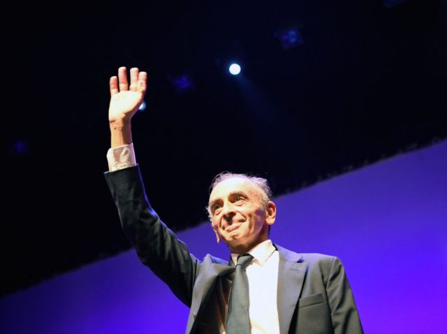France's far-right media pundit Eric Zemmour waves as he arrives on stage during his new book "France hasn't said its last word" (La France na pas dit son dernier mot) promotion launch event in Toulon, southern France, on September 17, 2021. - French far-right pundit Eric Zemmour is inching closer …