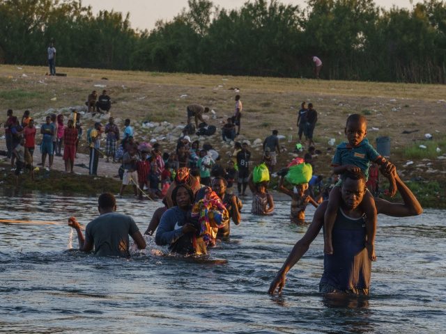 Haitian migrants continue to cross across the US-Mexico border on the Rio Grande as seen f