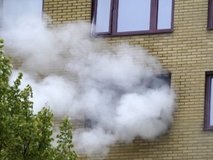 Smoke billows from a building at the site of an explosion in central Gothenburg on September 28, 2021. - At least 16 people were injured, including four seriously, in an explosion that tore through an apartment building, authorities said. Emergency responders added that the blast did not look like an …