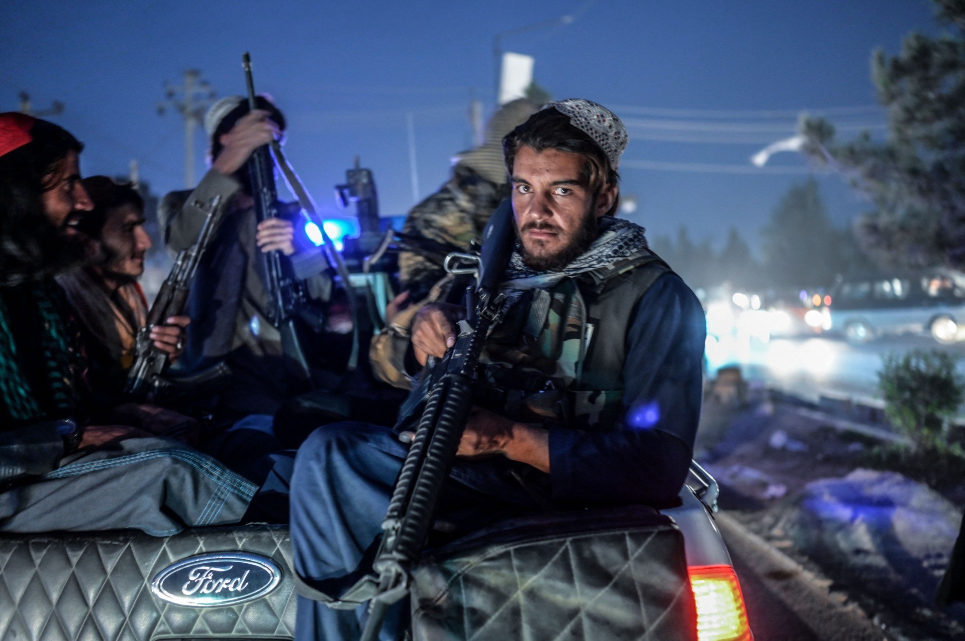 Members of the Taliban patrol on a pickup truck in Kabul on September 30, 2021. (Photo by BULENT KILIC / AFP) (Photo by BULENT KILIC/AFP via Getty Images)