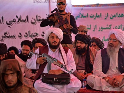 Taliban officials and commanders attend an open-air rally in a field on the outskirts of K