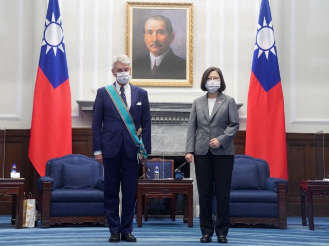 Taiwan President Tsai Ing-wen (R) and French Senator Alain Richard (L) pose for photos at