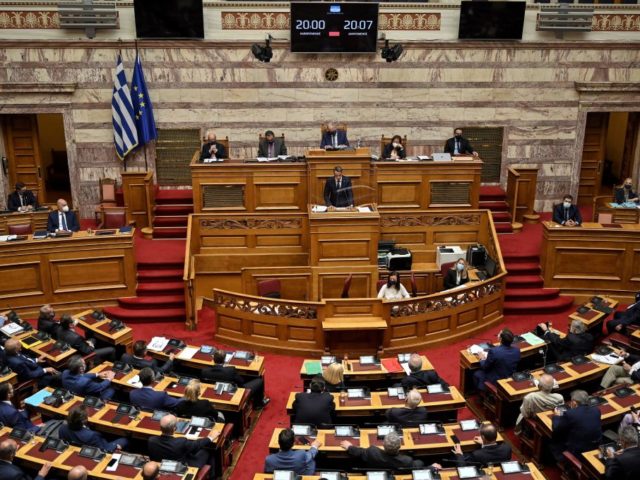 Greece's Prime minister Kyriakos Mitsotakis (C) addresses the Greek Parliament in Ath