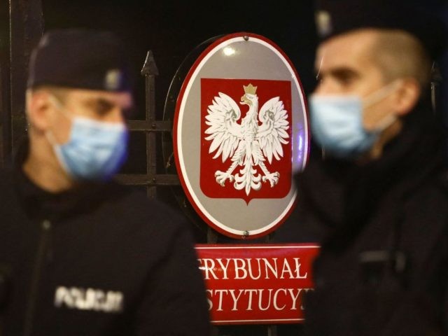 Polish policemen patrol in front of the entrance to the Constitutional Court with the coat